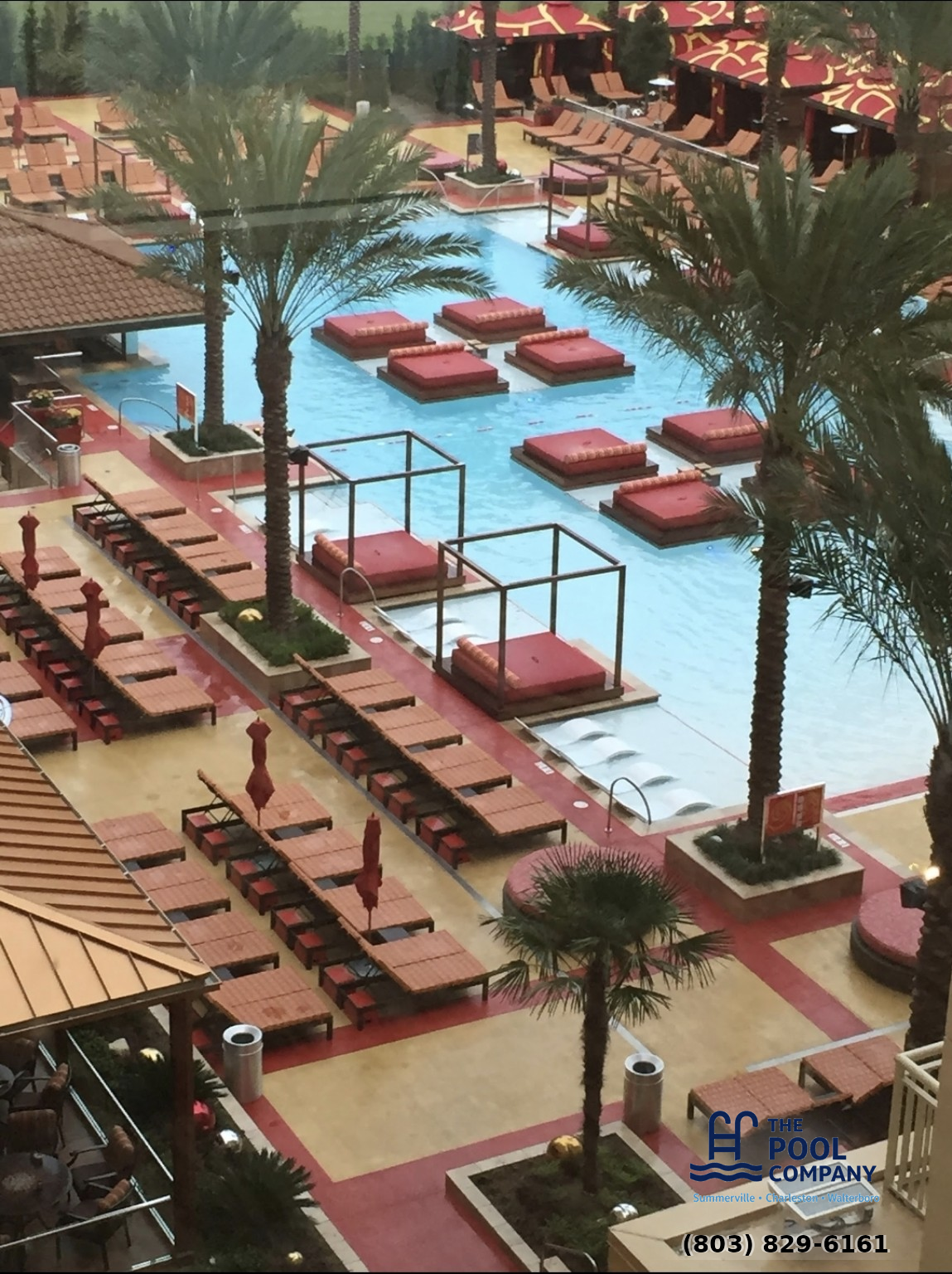 Large freeform pool cleaning in progress by Pool Company technician